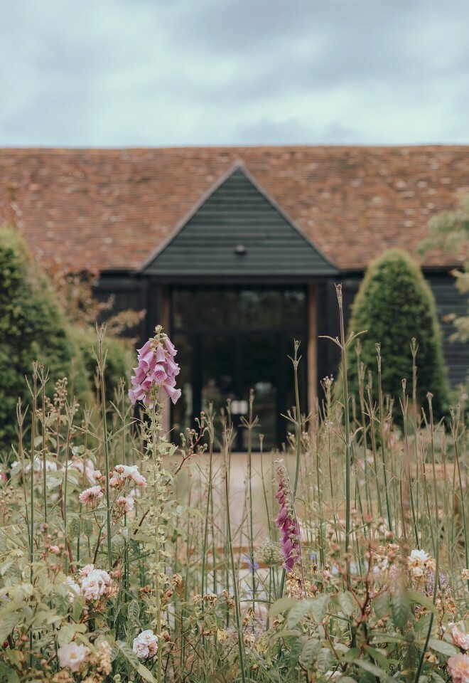 Wedding barn in East Sussex with wild flowers in foreground