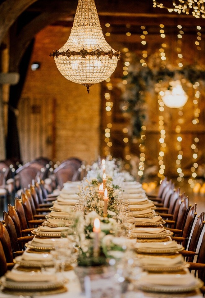 Barn wedding breakfast in The Thatched Barn at Tythe with chandeliers and fairylights.