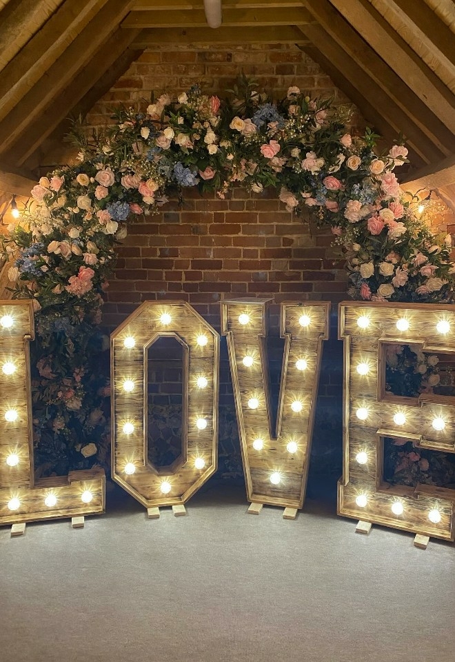 wooden love letter hire & flower arch from hire heaven venue decor buckinghamshire