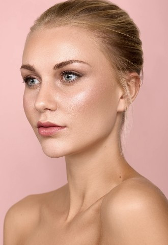 Softly defined eye makeup and glowing pinky tones makeup