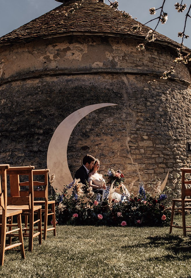 Crescent moon arch in front of the dovecote at dusk