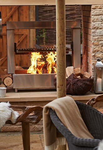 Roaring fires in outdoor covered seating area at Wild Thyme and Honey wedding venue in Cotswolds