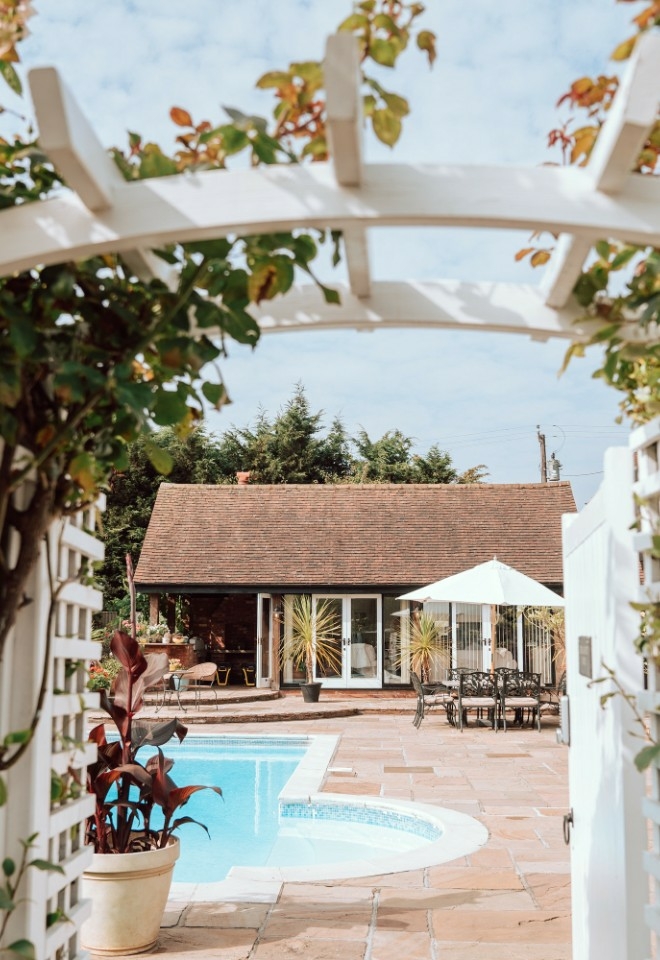 The exterior of dressing room with pool at High House Weddings in Essex