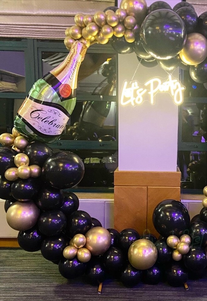 Let’s party balloon hoop with champagne bottle