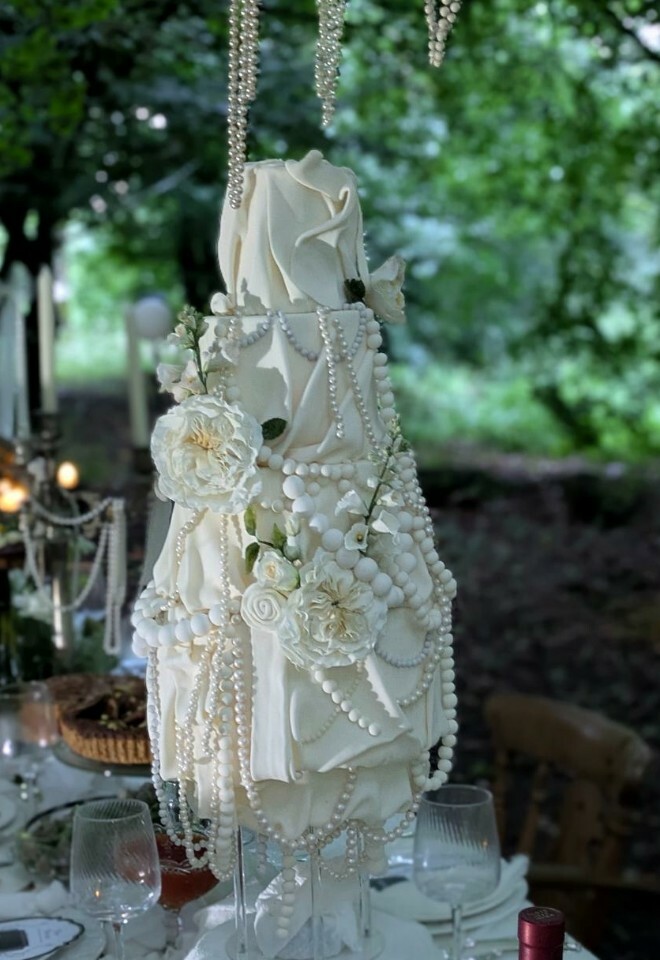 Modern drape cake with sugar pearls and sugar flowers 