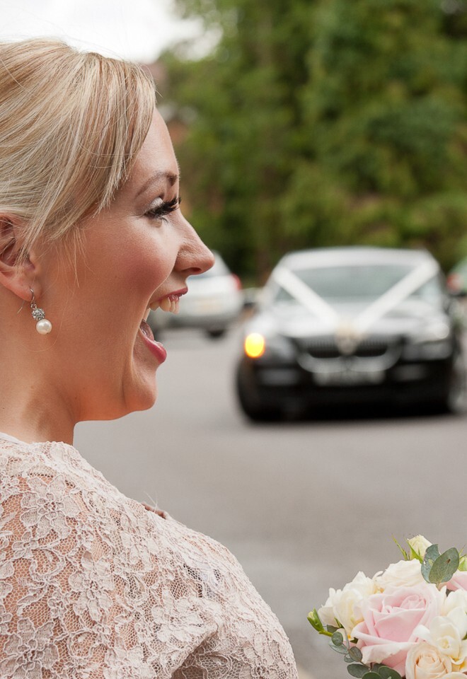 Bridesmaid is really happy to see brides car arrive at the church