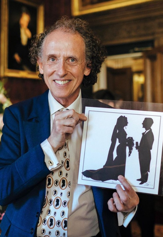 Charles Burns holding two silhouettes of a a bride and groom