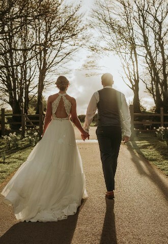 Happy couple walking into the sunset Trevenna Barns
