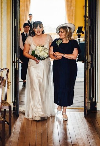 Bride walking down the aisle at Hagley Hall, Worcestershire
