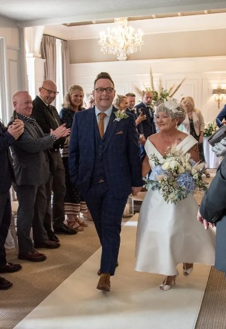 Bride and groom leave their wedding ceremony at Coed Y Mwstwr Hotel, Bridgend
