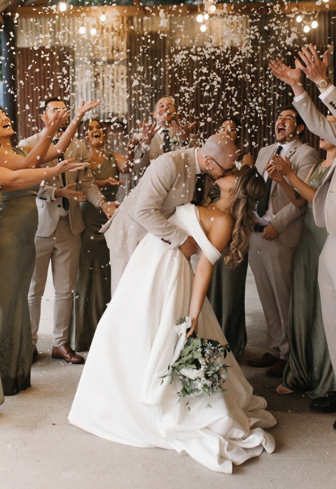 Couple kissing in the Dutch Barn with confetti