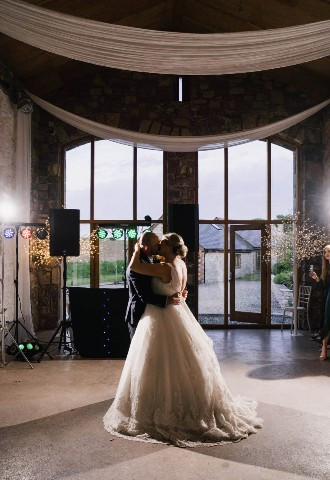 Bride and groom share their first dance at Rosedew Farm, Barn Wedding Venue South Wales