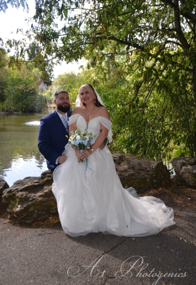 lakeside image of bride sitting on grooms lap in Swindon, photo by A1 photogenics, Wiltshire
