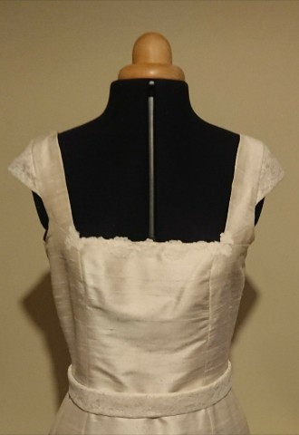 Cream silk dupion dress with a belt, trimmed with English lace