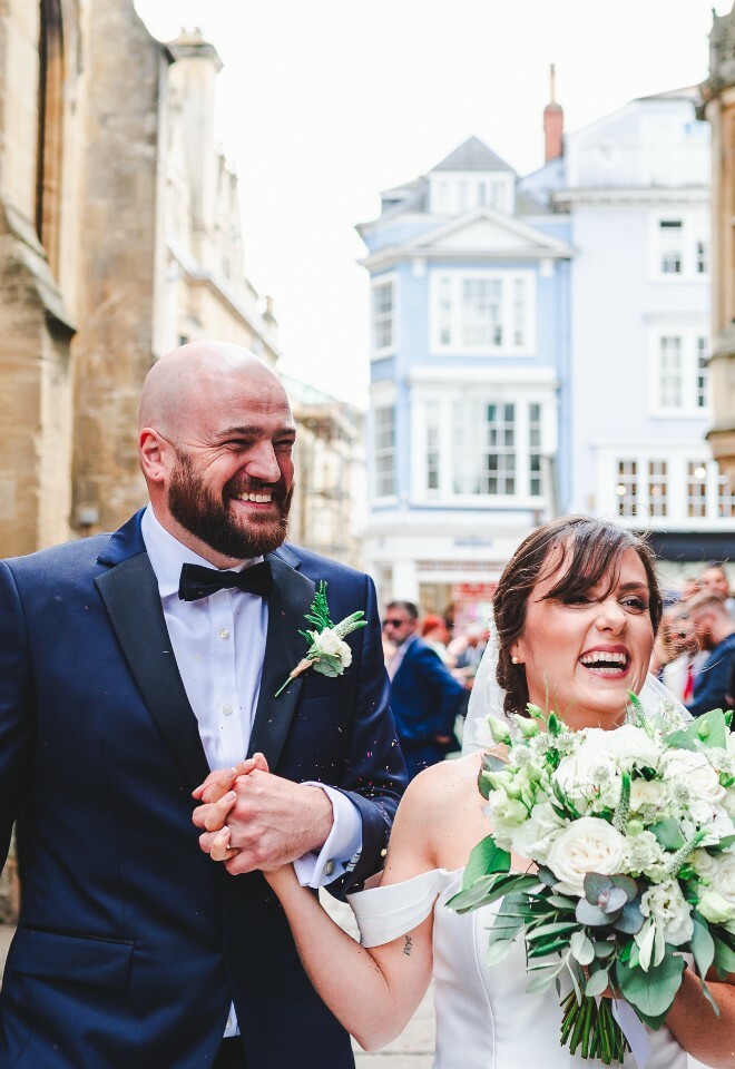 bride and groom confetti run in city centre
