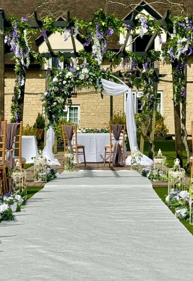 Floral archway, wisteria garlands, aisle dressing and chair dressing 