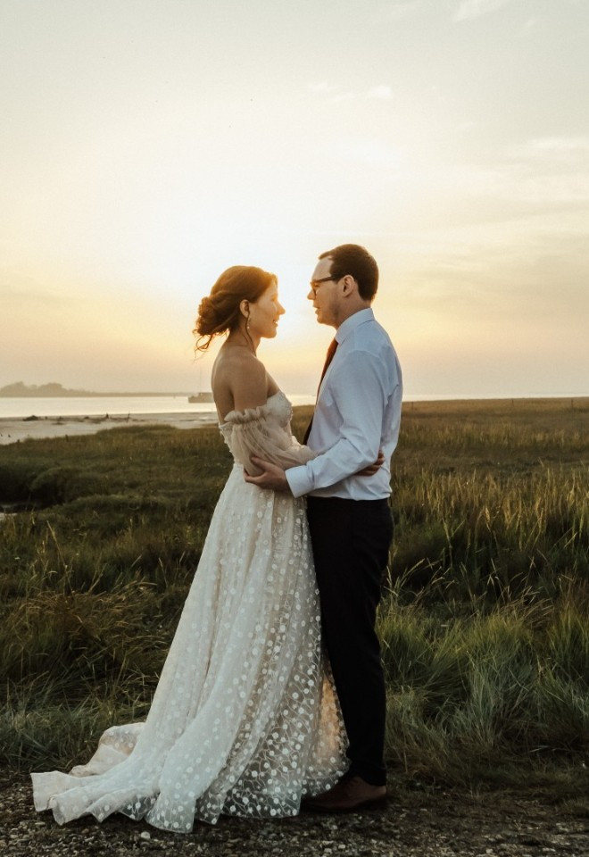 Bride and groom beside the Kent estuary at The Harty Estate at twilight