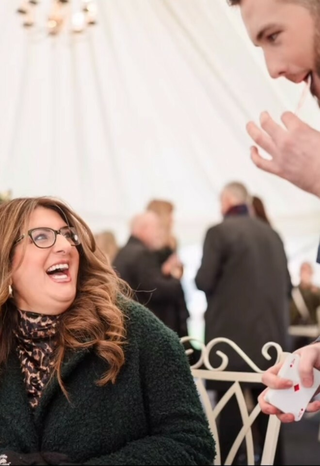 performing a card trick for a wedding guest