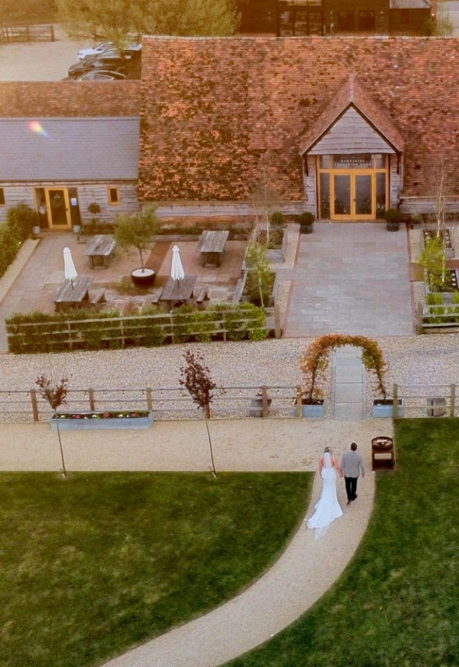 Bride and groom walking to the Hampshire Threshing Barn