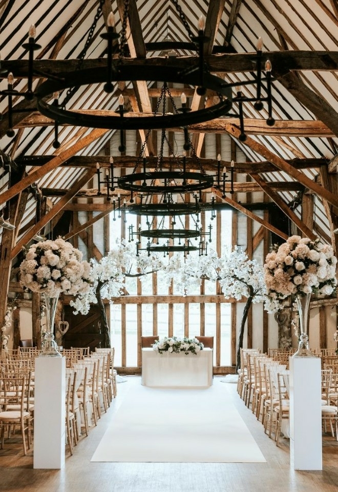 Wedding barn with decor trees vases carpet plinthes