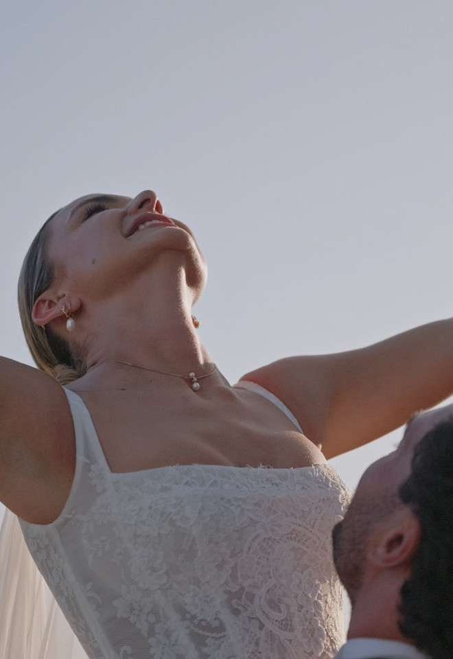 Groom lifting bride in the grounds of Danesfield House, Buckinghamshire, captured by Dean Sherwood Wedding Films, Hertfordshire wedding videographer.