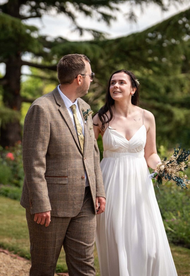 Bride and groom walking in the gardens