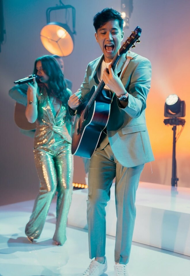 The collective performing live at a wedding with singer and guitarist