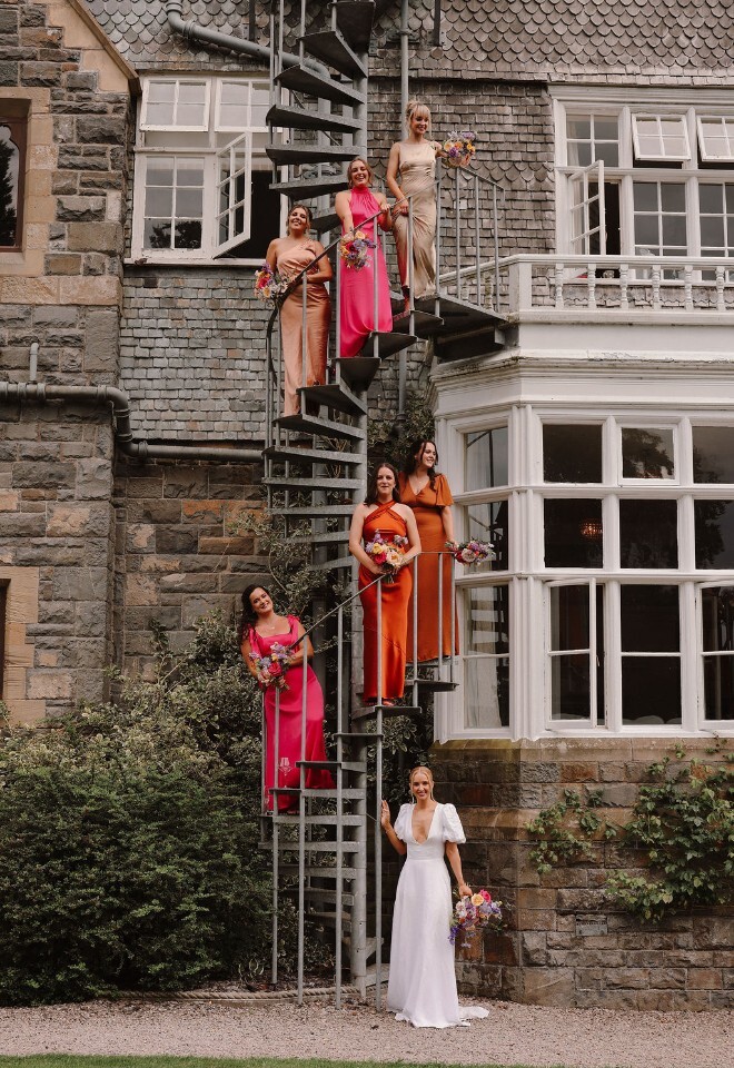Bride and bridesmaids stood on stairs