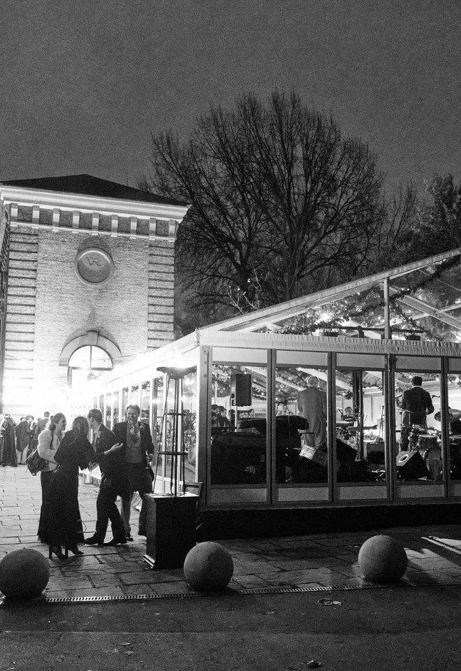 Black and white photo of a wedding reception in Battersea Park with a glass marquee  hosting the event
