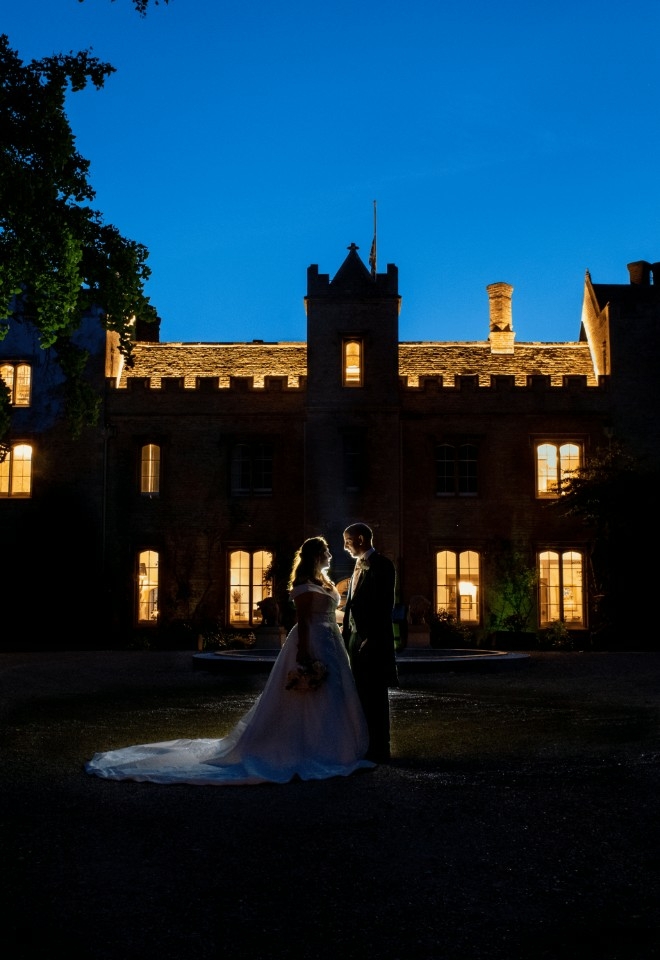 close up manor in the dark with bride & groom embraced