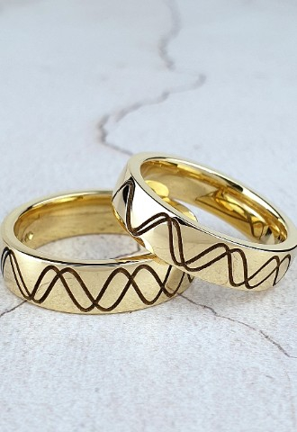 bespoke wedding bands in 18ct yellow gold with laser-engraved design