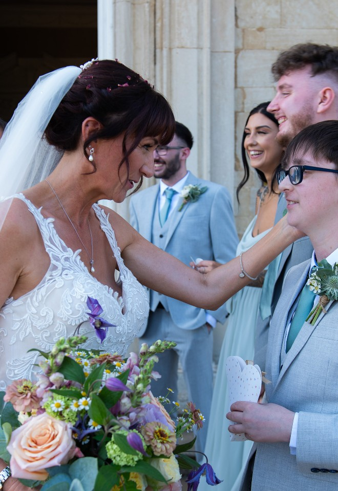 A mother, in full bridal outfit, reassures her teenage son that he is still her number one after marrying her long time fiance at Stapleford Park