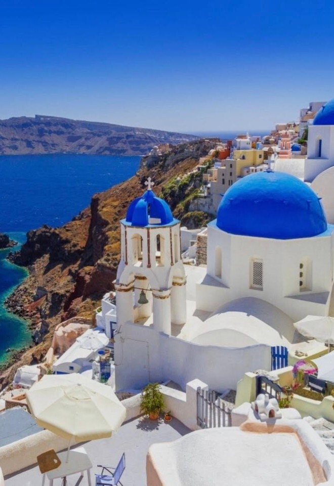 Spectacular views of Santorinis blue-domed churches on a tailor-made honeymoon by Not Just Travel James & Natasha