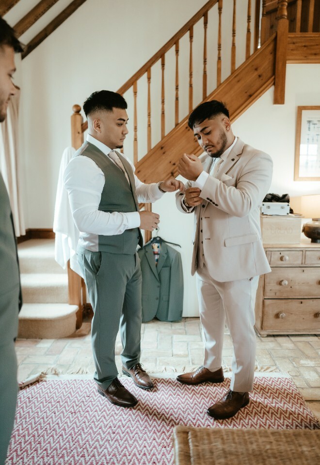 Groom and groomsmen getting ready in the onsite accommodation before the ceremony