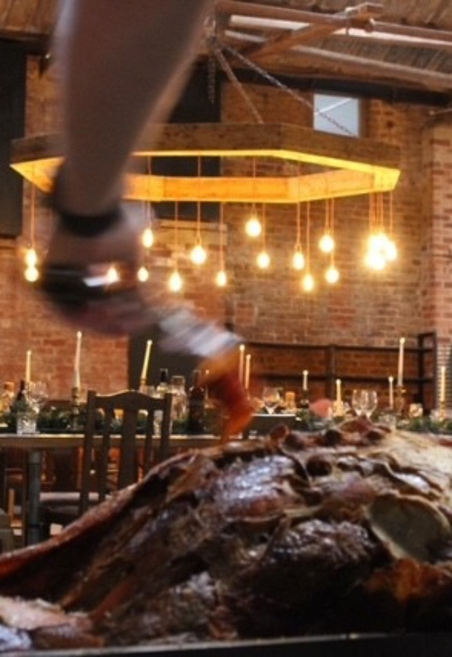 Whole roasted hog being carved and served at a Lancashire wedding venue
