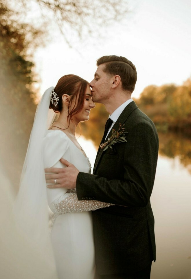 Married couple posing by the river