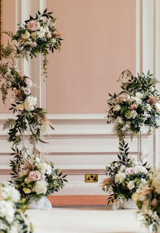asile style floral arch arrangement by make it special events