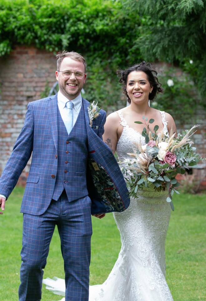 Bride and Groom smiling in gardens 