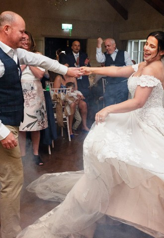 Bride and groom share their first dance at Coed Y Mwstwr Hotel wedding venue, Bridgend