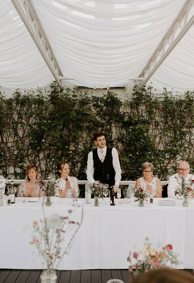 Groom giving speech in conservatory