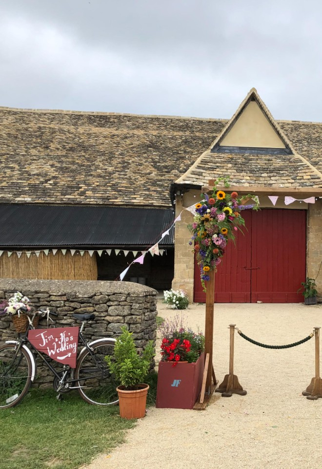 Rustic floral wedding arch with bunting