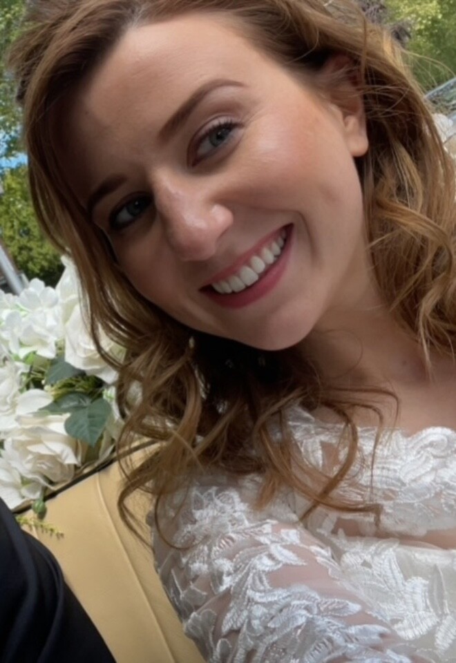 Bride smiling on her wedding day with soft glam bridal makeup.