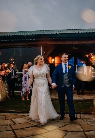 COuple outside Skylark Weddings Venue in Northamptonshire. Guests with Sparklers