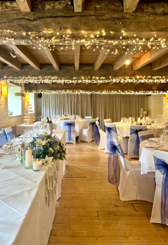 Romantic and rustic wedding breakfast setting with fairylights