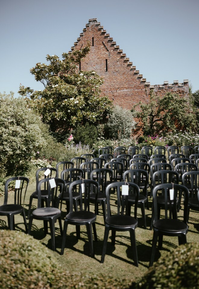 Outdoor Ceremony set up, reserved seating, barn in the background