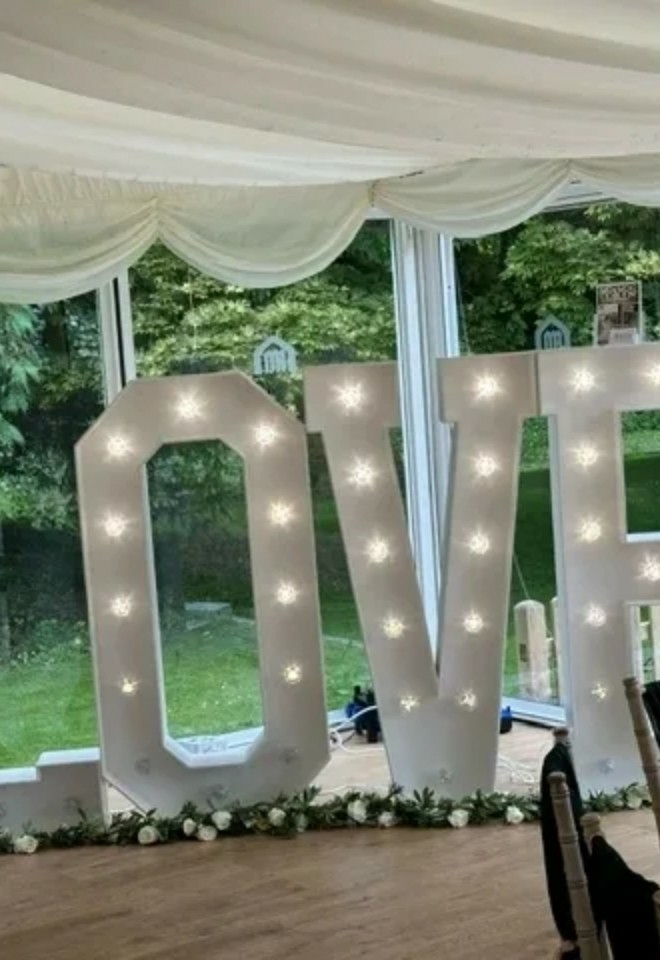 love letters with lights in wedding venue