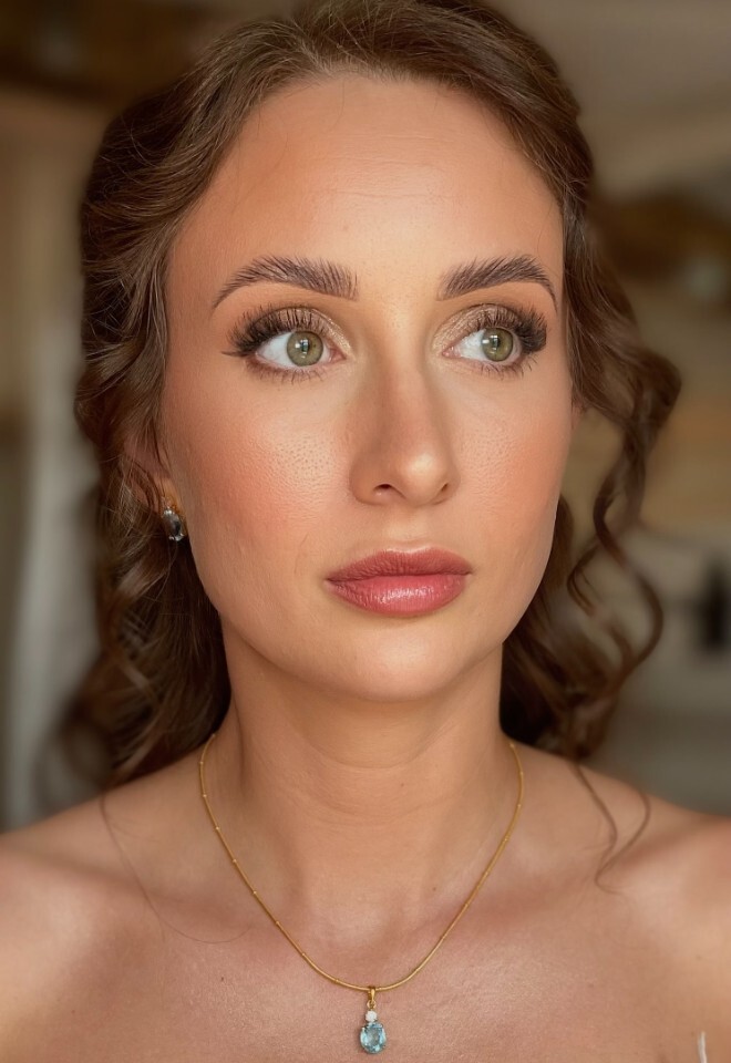 Soft glam bridal makeup with a half up half down bridal hairstyle 