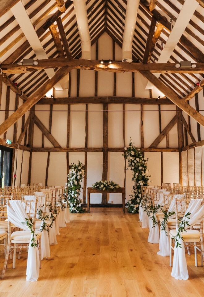 Simple wedding ceremony setting inside Alfriston Gardens barn