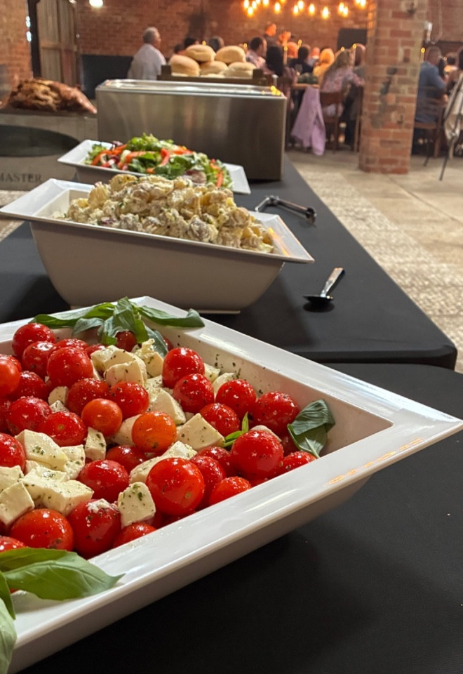Caprese salad with cherry tomatoes, mozzarella and fresh basil at a wedding