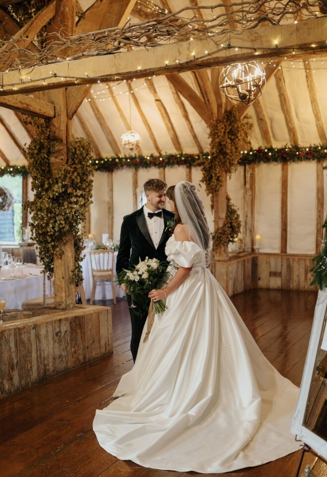 Couple at Christmas inside Winters Barns 